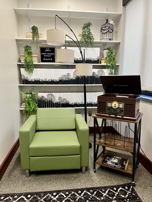 The record player and green armchiar in the new student media viewing room.